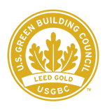Gold LEED certification badge with stylized leaf design.